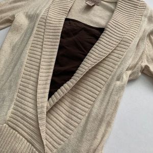 Cream crossover sweater with buckles
